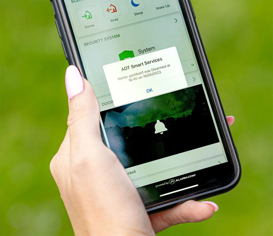 ADT alarm interface on smartphone showing disarm notification