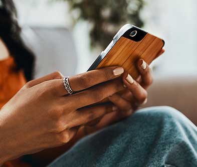 Hand shot of woman holding smartphone